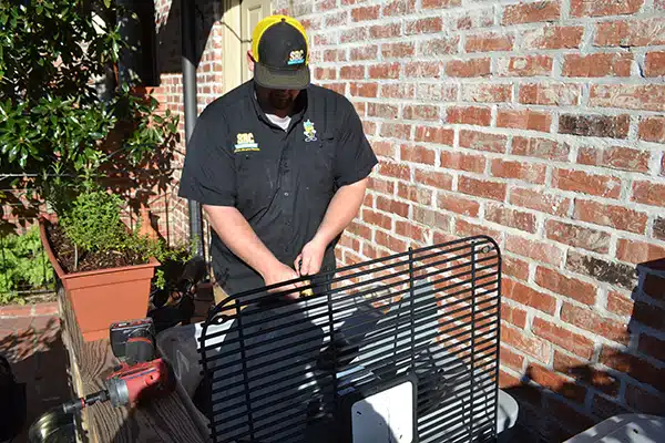 SBC tech repairing HVAC system in Shreveport LA.
