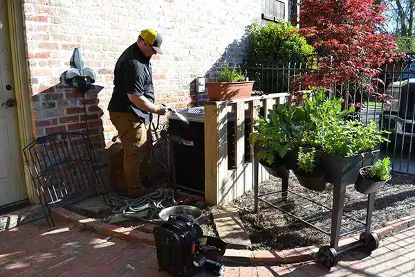 SBC tech working on air conditioner outside of residential home in Shreveport LA.