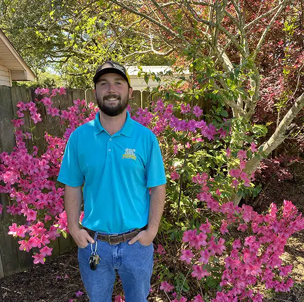 SBC tech standing in backyard in Shreveport LA.