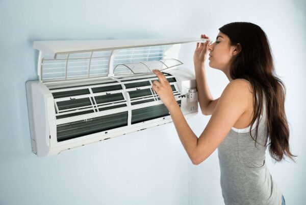 woman looking at broken AC in Shreveport LA