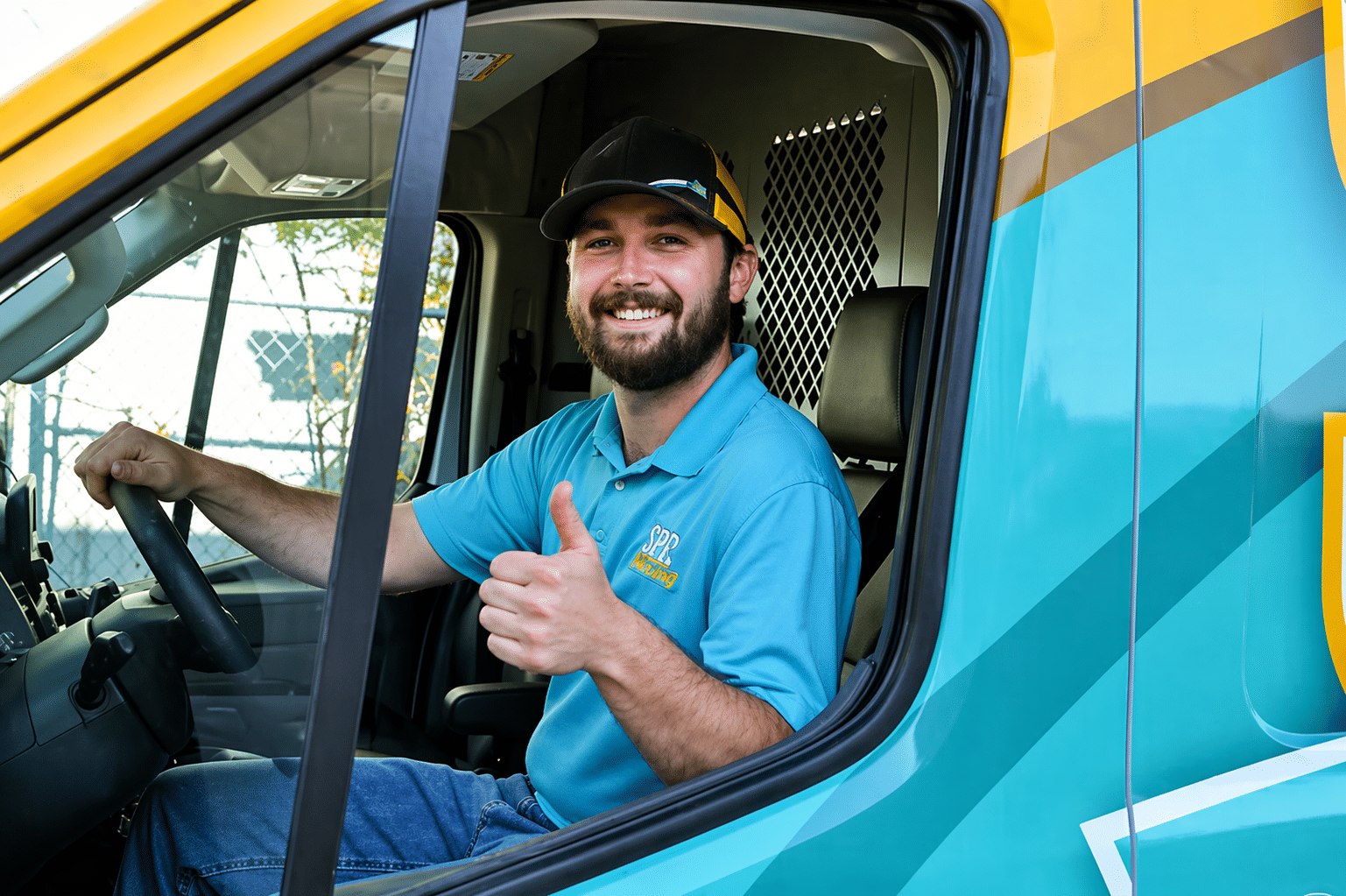 SBC tech inside of fleet truck smiling giving a thumbs up in Shreveport LA.