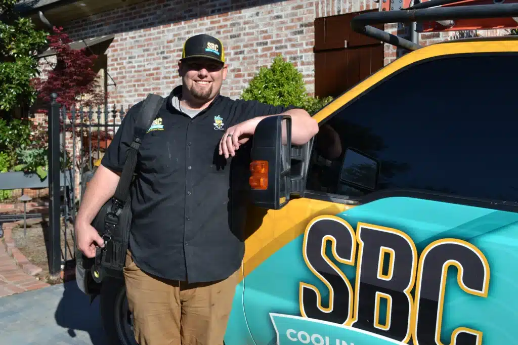 SBC tech leaning against truck in front of residential home in Shreveport LA